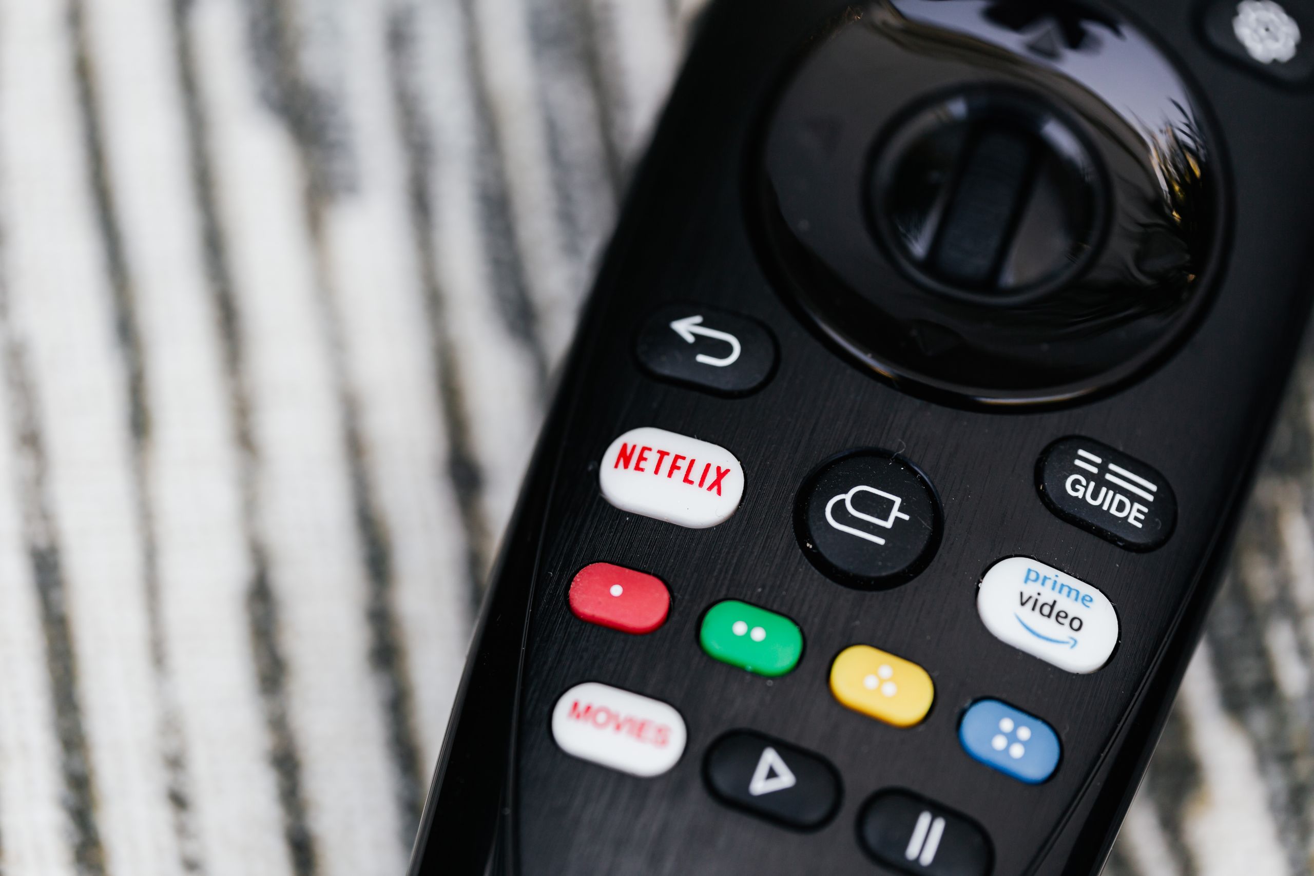 Detailed image of a remote control featuring streaming service buttons.